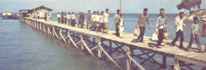 Refugees transported to Pulau Bidong island walking on the jetty.